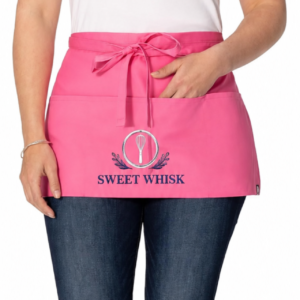 Black custom embroidered apron with Sweet Whisk bakery logo centered on the front